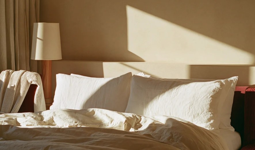Made hotel bed with white pillows