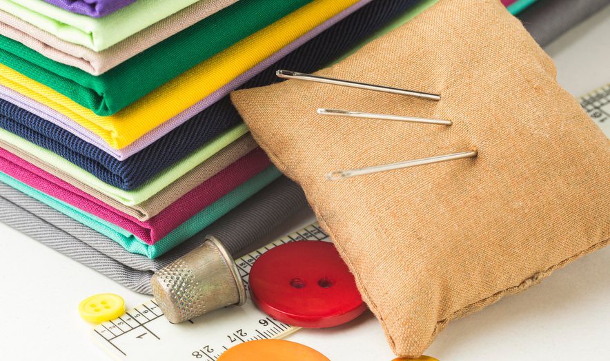 Colourful fabrics with a pin cushion and buttons
