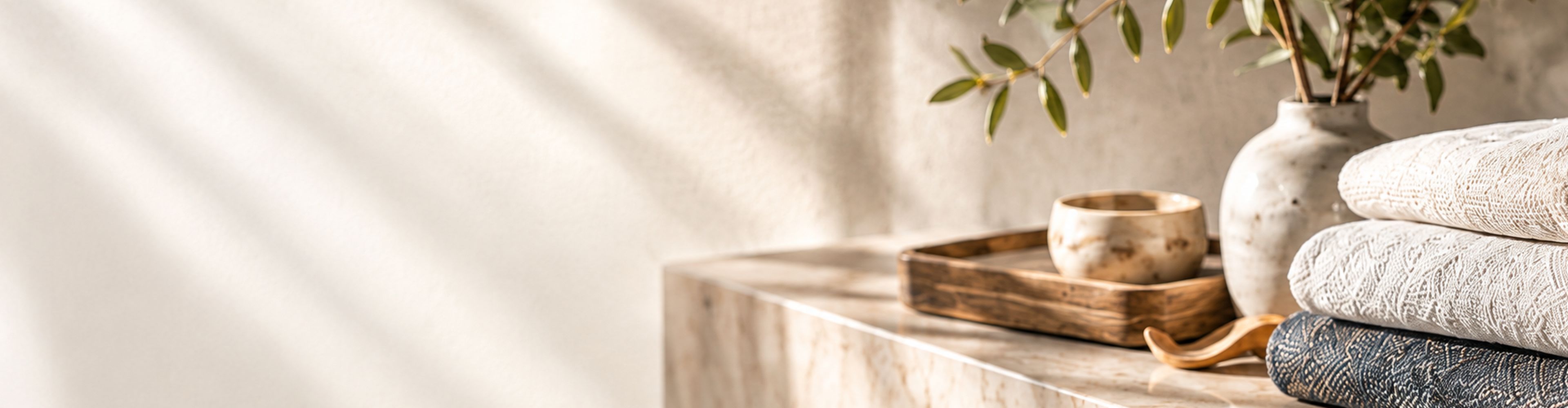 Folded textured throws on a stone table