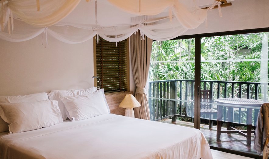Resort bedroom opening onto a garden